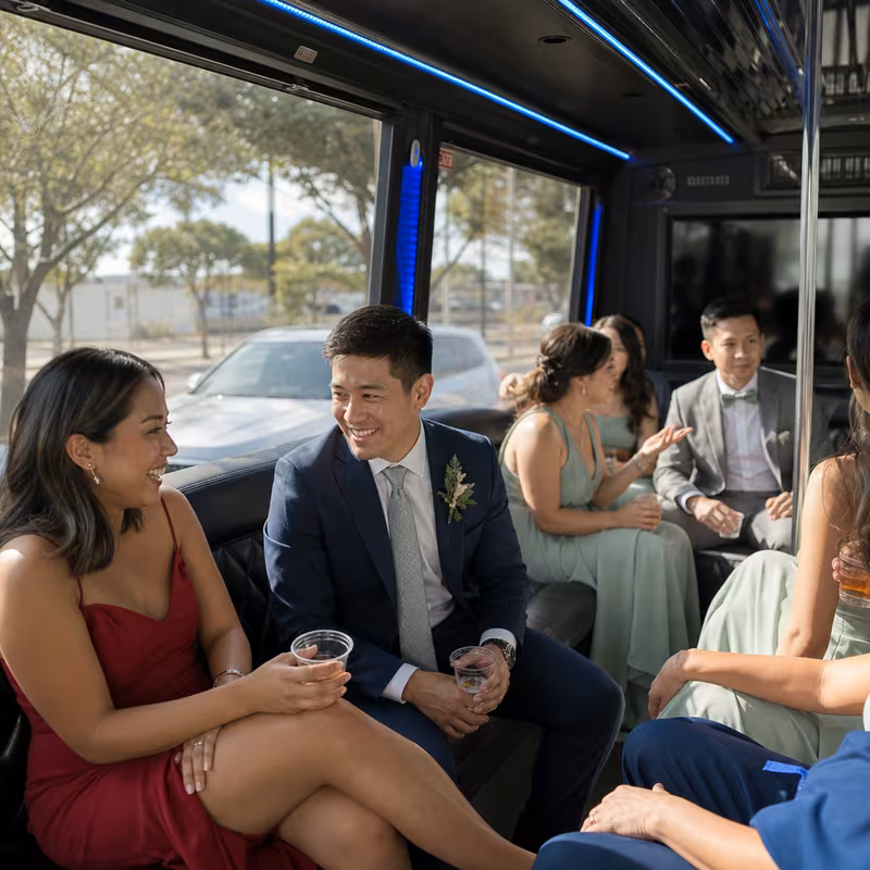 Wedding guests seated inside a Oakland party bus