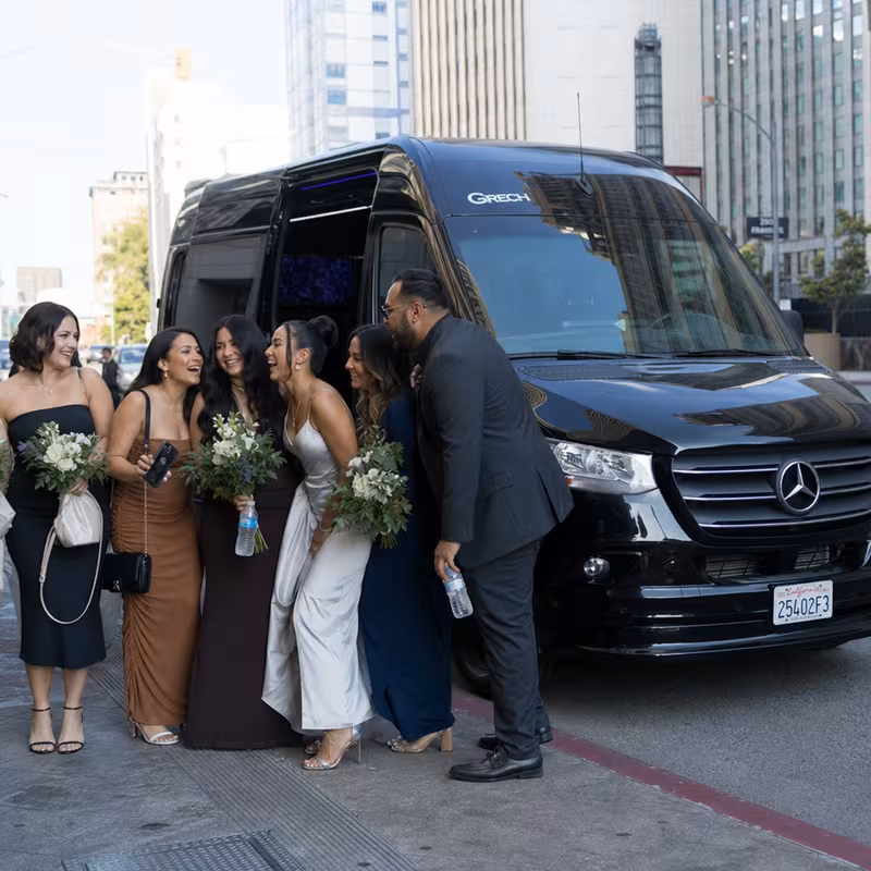Group boarding a white charter bus for Bachelor & Bachelorette Transportation transportation in Oakland