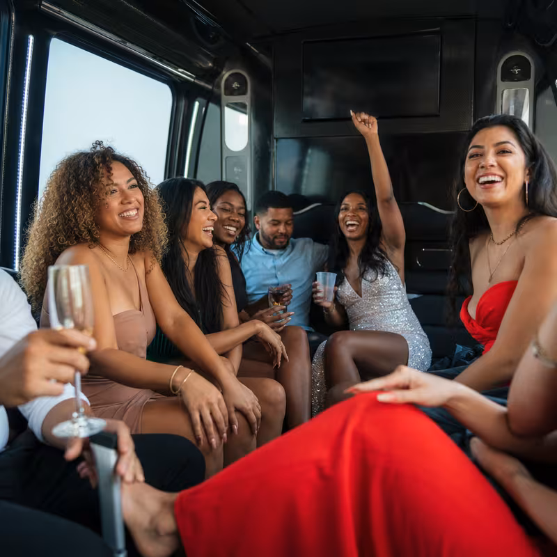 Party bus interior with wraparound leather seating and LED lighting in Oakland