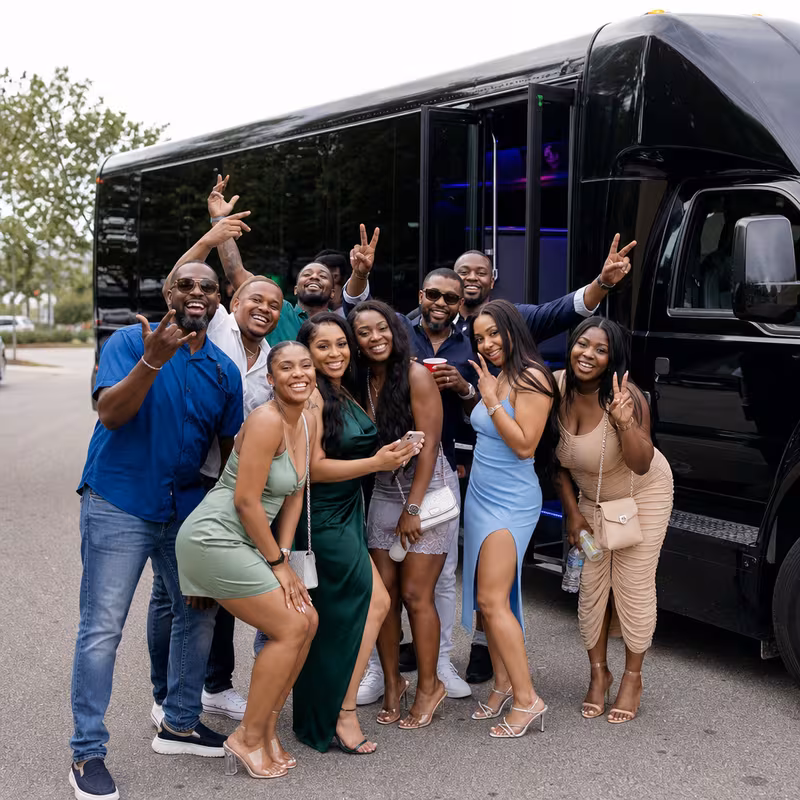 Group boarding a white charter bus for Birthday Transportation transportation in Oakland