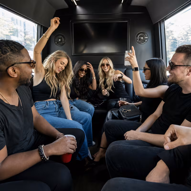 Group boarding a white charter bus for Concert Transportation transportation in Oakland
