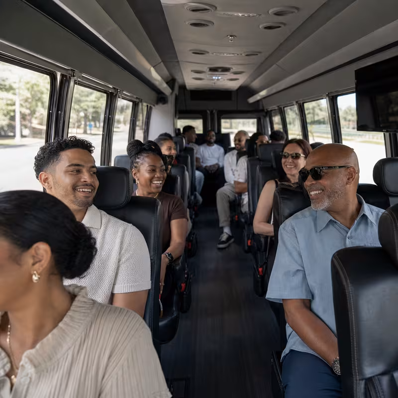 Group boarding a white charter bus for Private Event Transportation transportation in Oakland