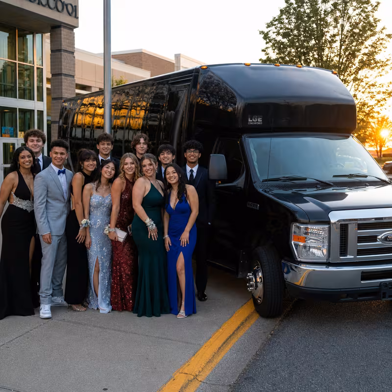 Group boarding a white charter bus for Prom & Homecoming Transportation transportation in Oakland